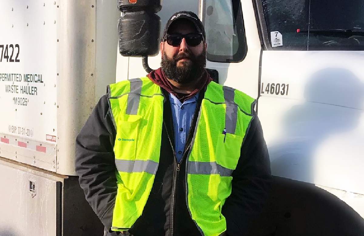 Stericyle Driver In Front Of Truck